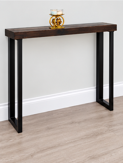Handmade black asymmetric metal console table legs supporting a narrow dark wood hallway table