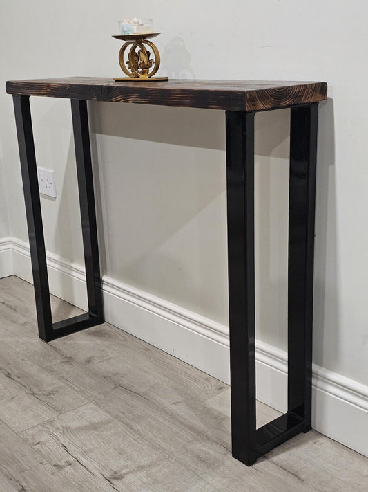 Front angled view of a wooden console table on black steel legs