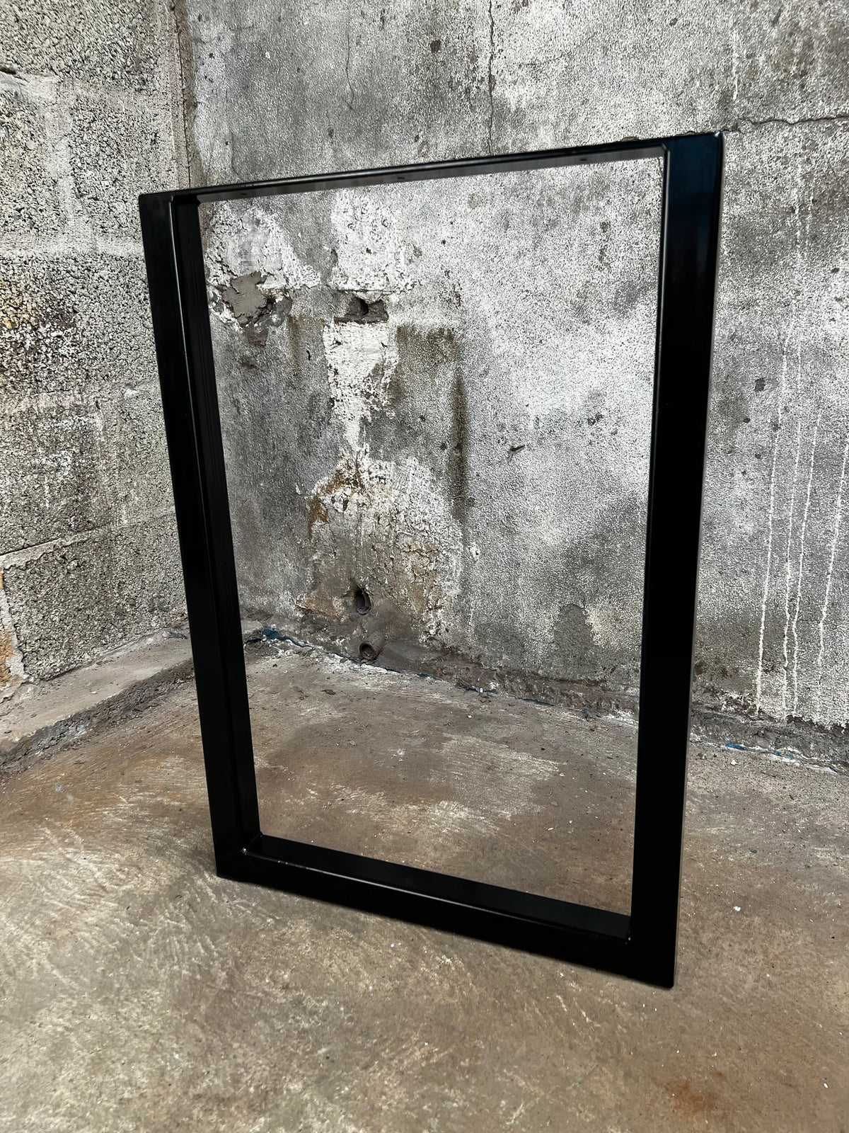 Angled view of a black rectangular steel table leg