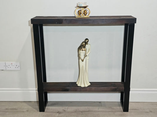 Front view of a black steel console table frame with wooden top and lower shelf